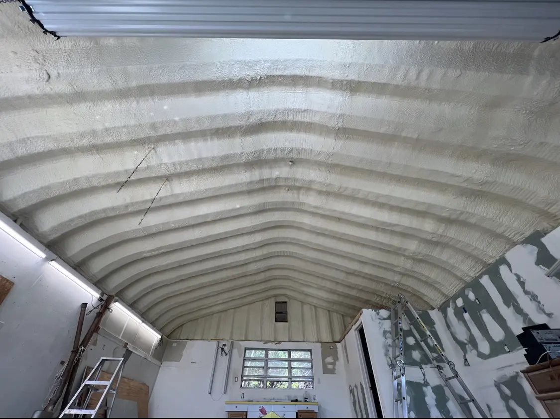 Spray polyurethane foam applied to the underside of a metal roof deck in Jefferson City